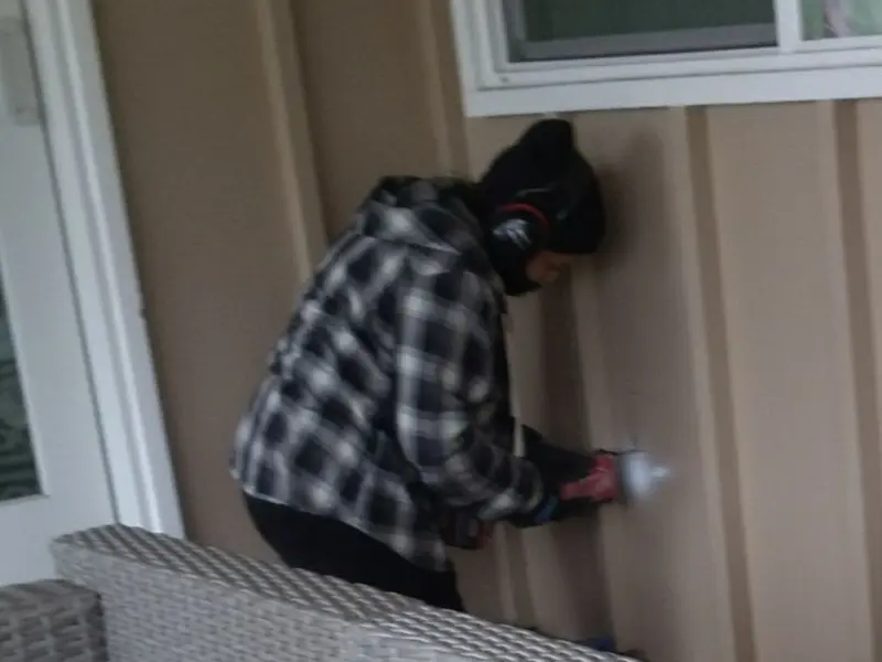 Professional electrician installing an exterior outlet in Dayton